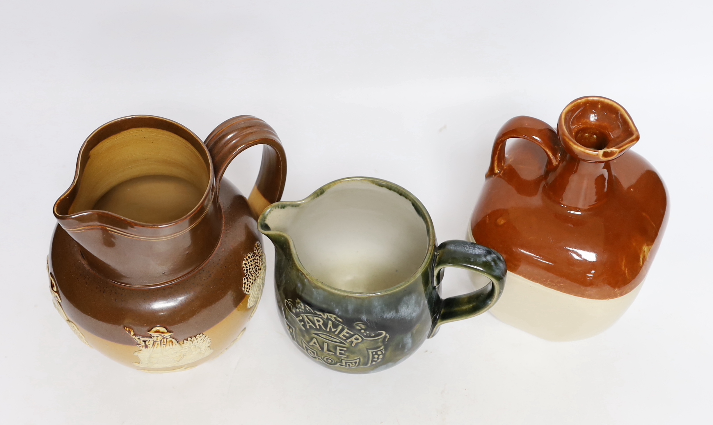 Two Doulton stoneware jugs and a Long John whisky ewer, largest 17cm high